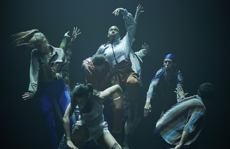 A group of dancers pose in different positions