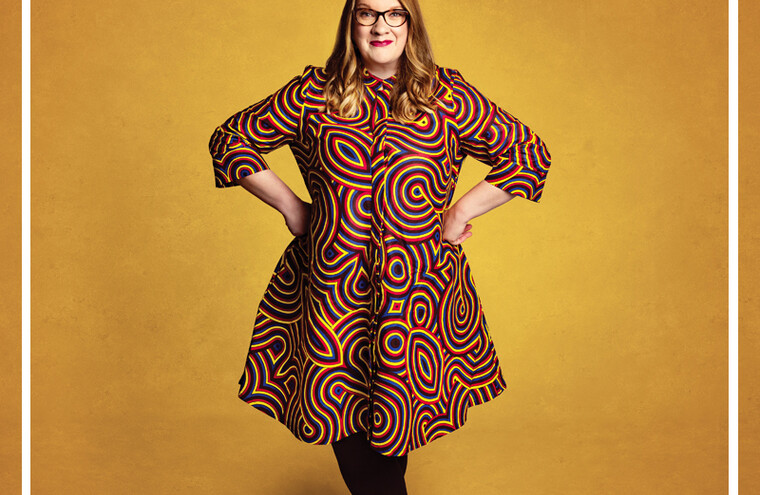 Sarah Millican stands with her hands on her hips.