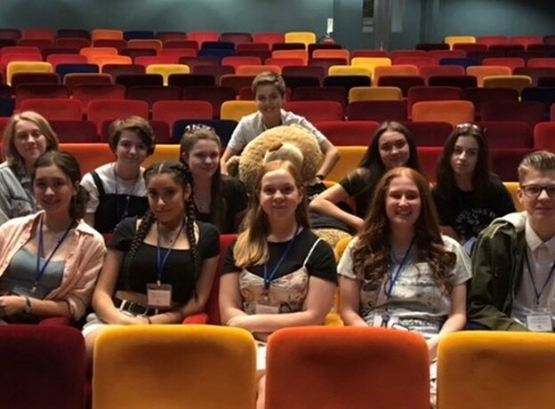 A photograph of a group of previous Playhouse work experience students sitting in the auditorium.